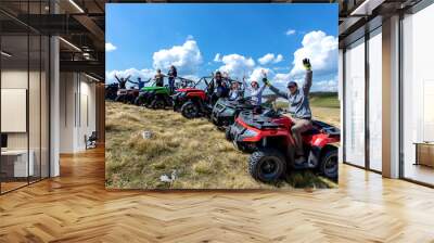 Friends driving off-road with quad bike or ATV and UTV vehicles Wall mural