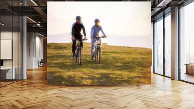 Happy mountainbike couple outdoors have fun together on a summer afternoon Wall mural