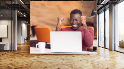 Happy successful African American businessman in a modern startup office indoors Wall mural