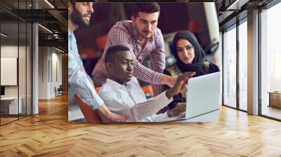 Multiracial contemporary business people working connected with technological devices like tablet and laptop Wall mural