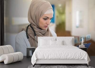 portrait of worried muslim female Medical doctor holding paperclip in hospital Wall mural