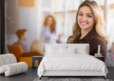 portrait of young business woman at modern startup office interior, team in meeting in background Wall mural