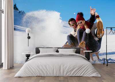 Young Couple Sledding And Enjoying On Sunny Winter Day Wall mural