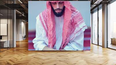 Younger Muslim Arabic man praying Wall mural