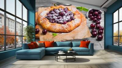 Open pie tart dough with ripe cherries Wall mural