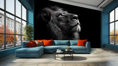 Close-up of a majestic lion's face, looking up, with a dark background, highlighting its powerful features. Wall mural