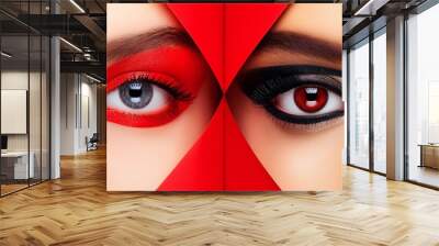 Close-up of two eyes with contrasting makeup, one with red eyeshadow and the other with black eyeshadow. Wall mural