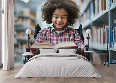 Happy young girl in a wheelchair reading a book in a library. Wall mural