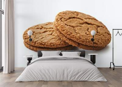 Two round, brown, crispy cookies with a sugary texture on a white background. Wall mural