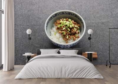 Natto, fermented soybeans on steamed rice in bowl and wooden chopstics on table Wall mural