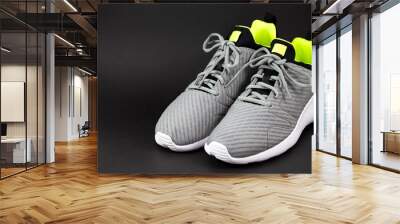 Shop display of new sneakers running shoes for men isolated on the black background. Wall mural