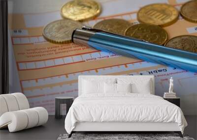 Banking slip with pen and loose coins Wall mural