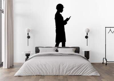 silhouette engineer using mobile phone texting while walking. Wall mural