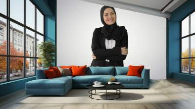 Smiling Arab businesswoman wearing hijab posing for the camera o Wall mural