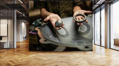 Hands designing handpan in a workshop Wall mural