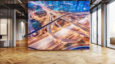 Aerial view of big highway interchange with traffic in Dubai, UAE, at night. Scenic cityscape. Colorful transportation, communications and driving background. Wall mural