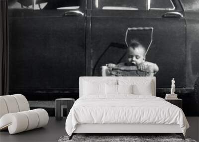 Vintage scene of a toddler eating watermelon beside an antique car Wall mural