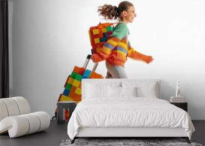 Joyful girl walking with colorful luggage in bright clothes Wall mural