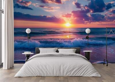 A dramatic sunset over a vast ocean with waves gently crashing onto the shore Wall mural