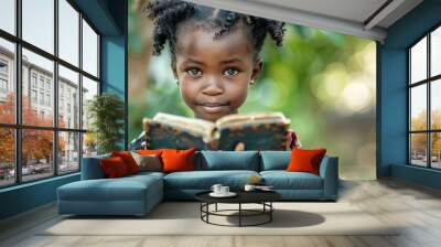 african child holding the holy bible with reverence and faith closeup portrait Wall mural