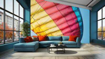 Close-up of a paraglider's colorful canopy against a clear blue sky, emphasizing the fabric and lines Wall mural