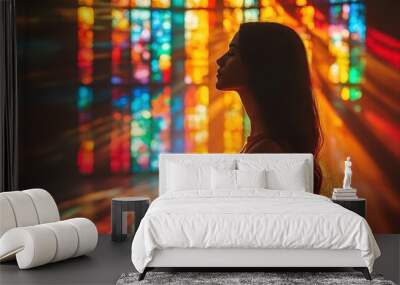 silhouette of woman praying in sunlit church stained glass windows casting colorful patterns spiritual atmosphere Wall mural