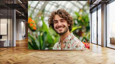 Studio portrait of a young European man with a floral theme, surrounded by flowers, isolated on a botanical garden background Wall mural