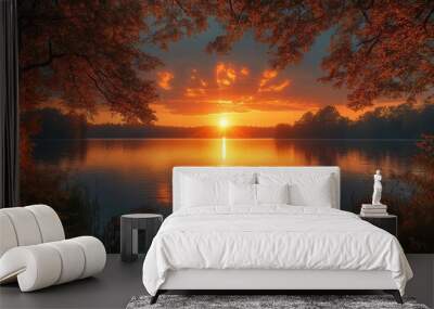 tranquil lakeside sunset golden light reflecting on still water silhouetted trees framing glowing sky in serene landscape Wall mural