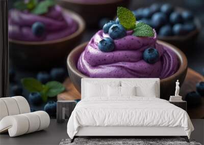 vegan blueberry sorbet swirls fresh mint garnish rustic wooden backdrop soft natural lighting vibrant purple hues appetizing texture ecofriendly presentation Wall mural