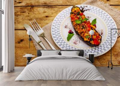 Karniyarik traditional Turkish food from stuffed eggplants with minced meat, tomato, greens and sesame seeds Wall mural