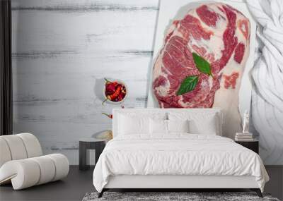 Raw pork neck meat. Traditional ingredients for cooking food. Garlic cloves, fresh parsley Wall mural