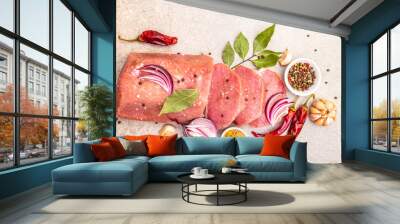 Raw pork tenderloin with vegetables and spices. Cooking meat background, fresh brisket boneless steak on stone background, top view, close up. Wall mural