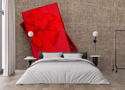 Red gift box on a woven background Wall mural