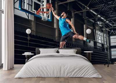  Black basketball player in action in a basketball court. Wall mural