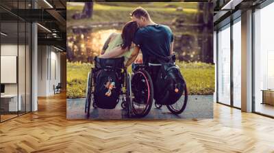  Handicapped young couple in wheelchairs in autumn park Wall mural