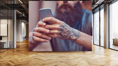 A handsome hipster male with a stylish beard and a tattoo on his Wall mural