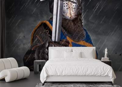 A knight with sword under the rain on battlefield. Wall mural