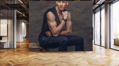 A man in a jeans and black t shirt. Wall mural