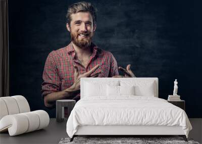 Bearded male dressed in a red fleece shirt makes conversation. Wall mural