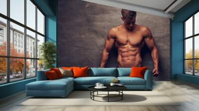 Beautiful shirtless young man model with nice muscular body posing at a studio. Wall mural