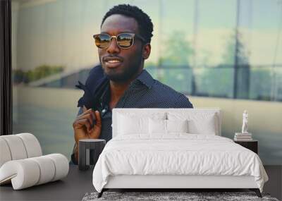 Black man over modern building background. Wall mural