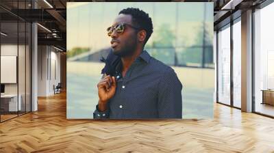 Black man over modern building background. Wall mural