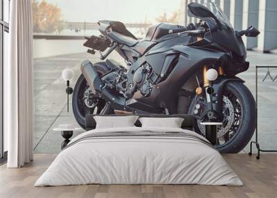 close-up photo of a black superbike outside near building. Wall mural