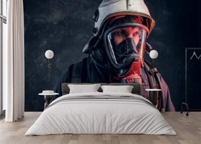 close-up portrait of a firefighter in safety helmet and oxygen mask. studio photo against a dark tex Wall mural