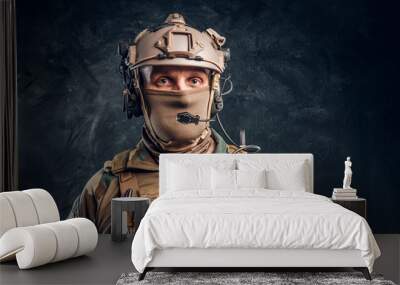 Close-up portrait. Private security service contractor in camouflage helmet with walkie-talkie. Studio photo against a dark textured wall Wall mural