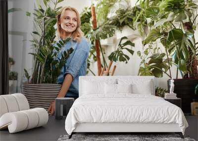 Ecofriendly businesswoman furnishing her place of work with houseplant Wall mural