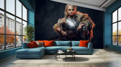 Fantasy woman knight wearing cuirass and fur, holding a sword scabbard ready for a battle. Fantasy fashion. Cosplayer as Ciri from The Witcher. Wall mural