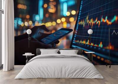 Hands using smartphone with financial charts in focus. Wall mural