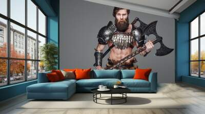 Handsome antique viking warrior with an axe in gray background Wall mural