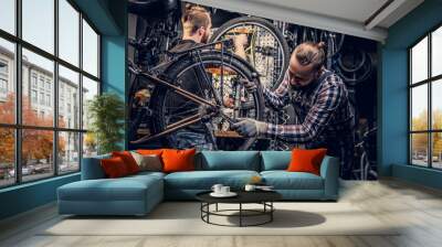 Mechanic fixing rear derailleur from a bicycle. Wall mural